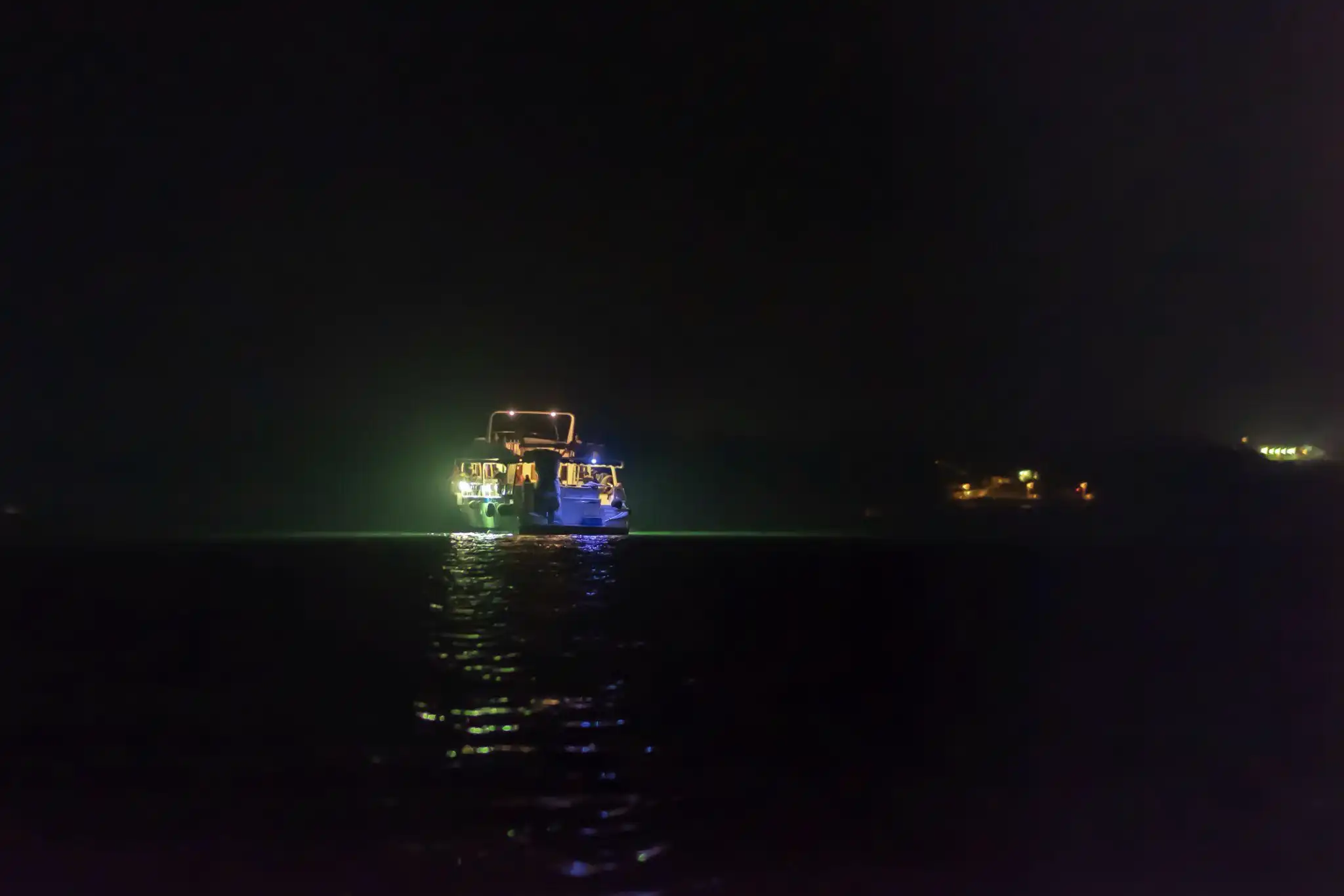 ship sailing at the sea at night